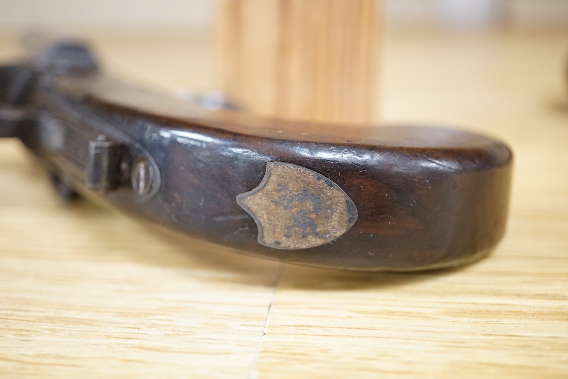 A double barrel flintlock, tap action pocket pistol by Collis of Oxford, with sliding top thumb safety, slab walnut grip, and tower private proof marks